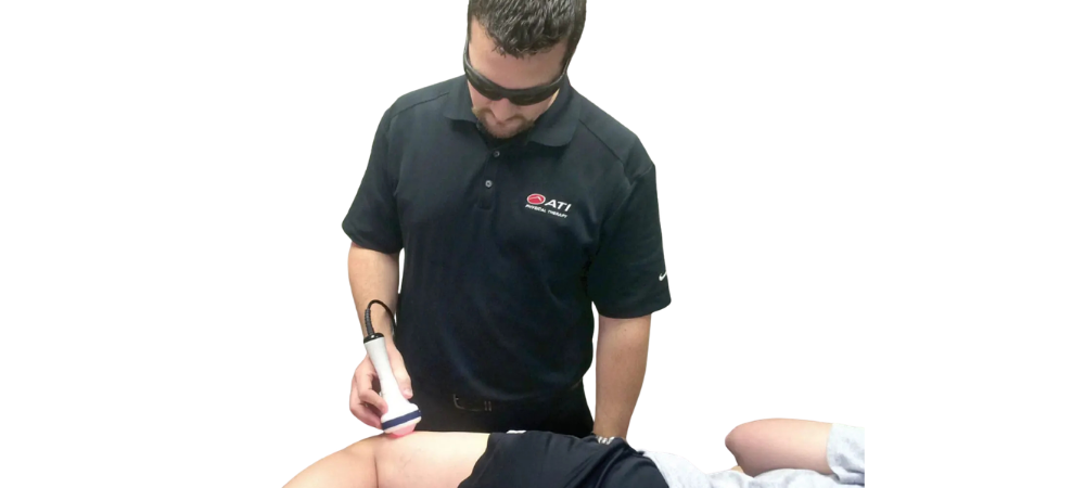 clinician applying laser to leg