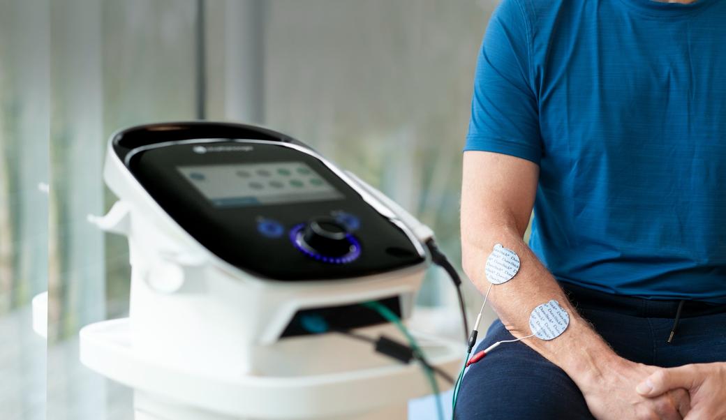 Intelect Legend 2 with Electrodes Placed on Male Patient's Arm