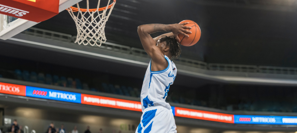man jumping to shoot a basket