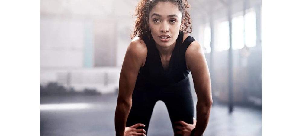 woman resting on knees after workout