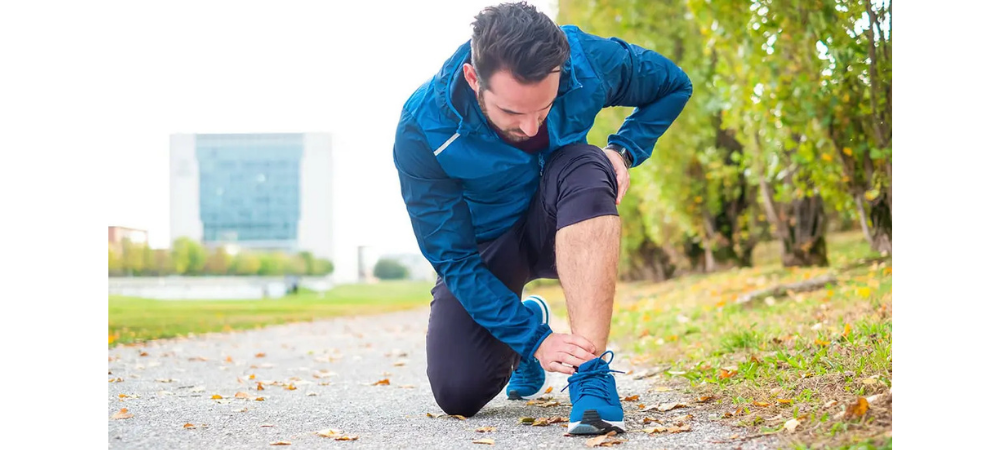 man in athletic gear with ankle pain