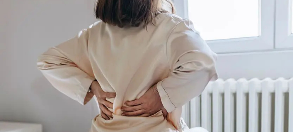 woman in robe with lower back pain
