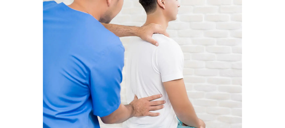 man with back pain, doctor palpating his back
