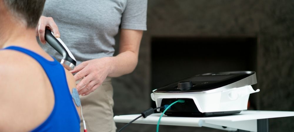 clinician using therapeutic ultrasound on patient shoulder