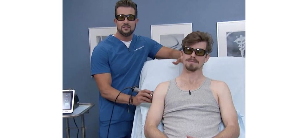clinician applying laser to patient shoulder