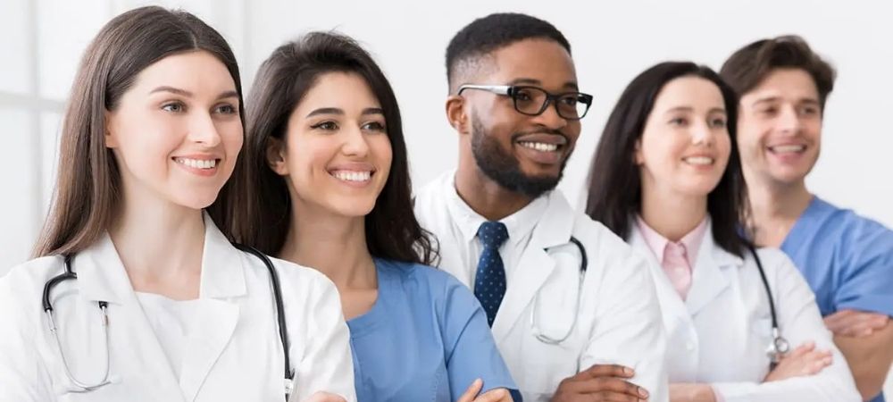 clinicians standing in a row smiling