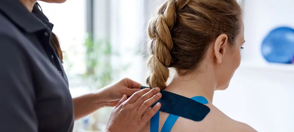 doctor applying tape to patient back